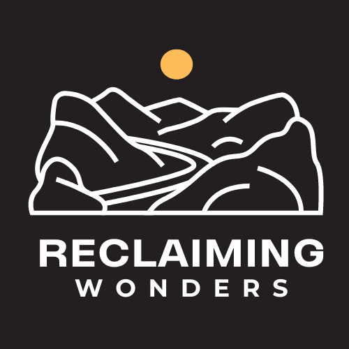 Black with white mountain and yellow sun - Reclaiming Wonders logo